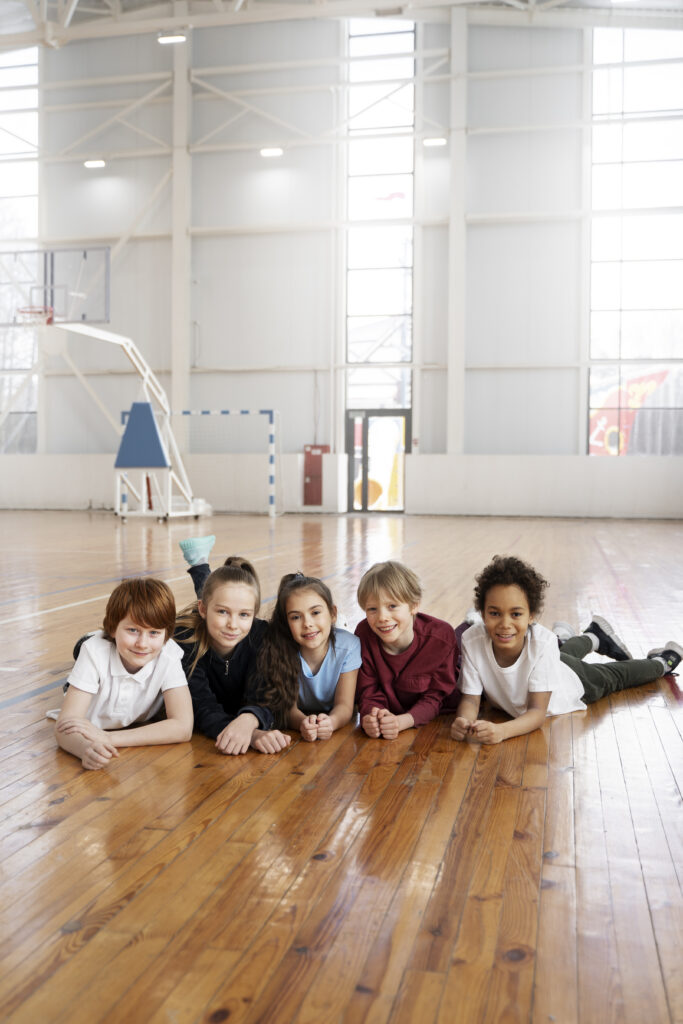 full shot happy kids laying floor (1)